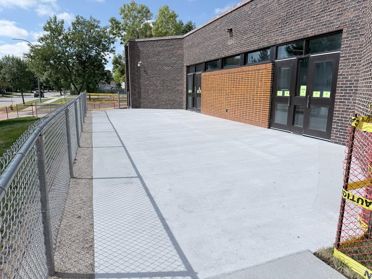 Redeveloped south entry at Chancellor School with new concrete and fencing